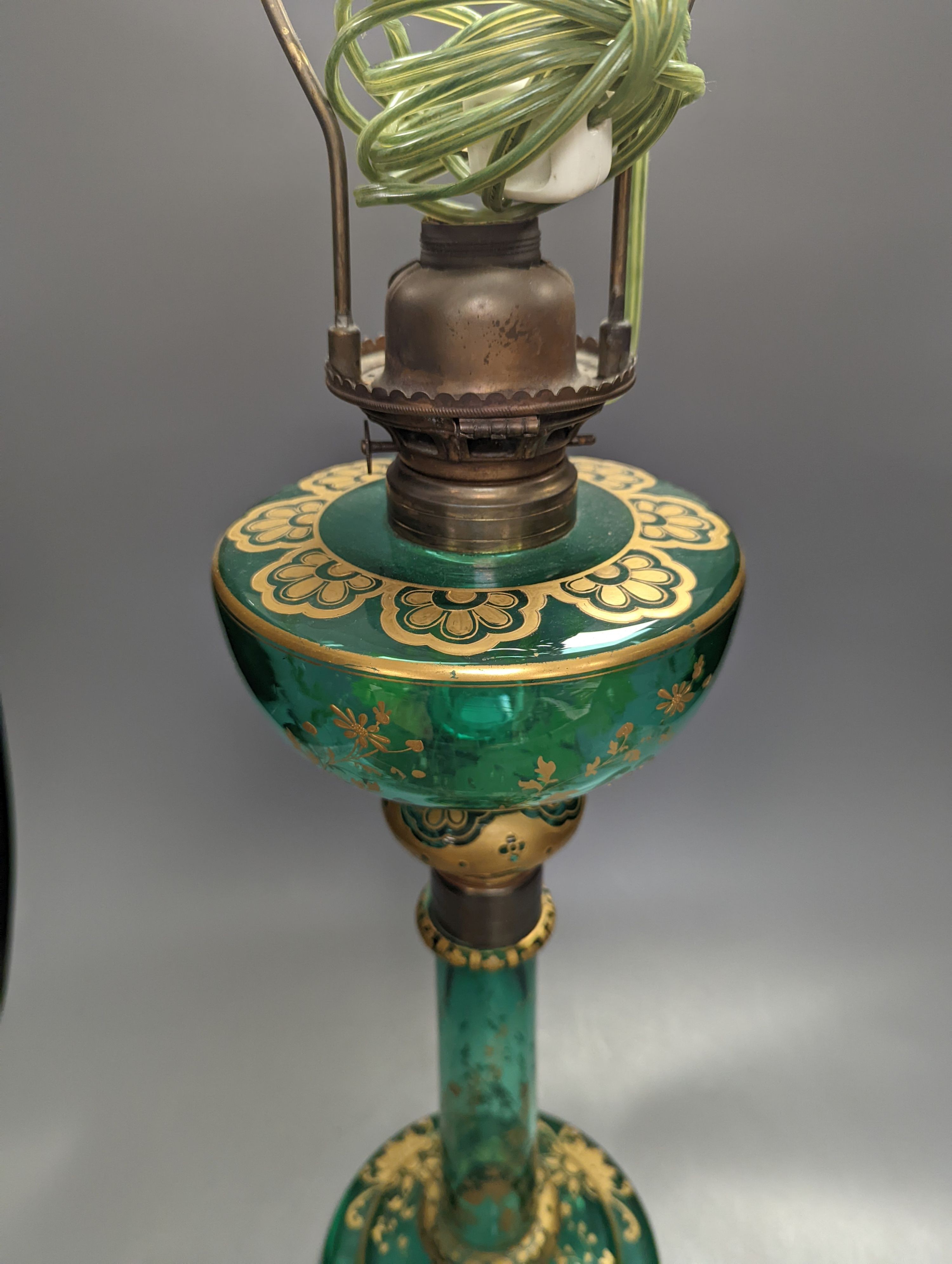 A tall Bohemian gilded green glass oil lamp, c.1900, height 48cm excl. light fitting